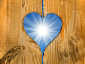 Shining sun in a wooden heart frame